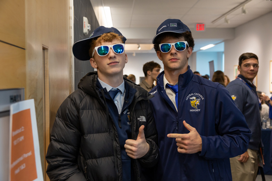 Two young men wearing caps and sunglasses