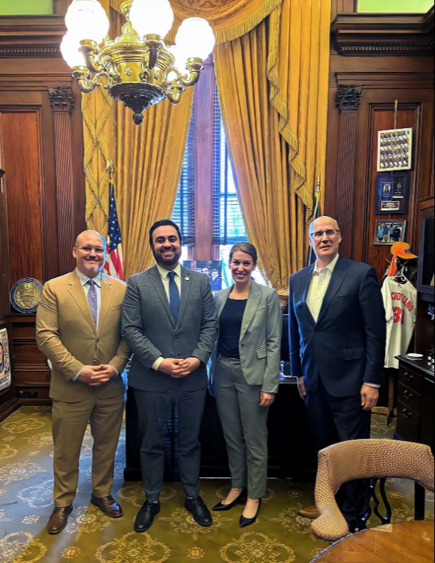 Jennifer Cryder, Greg Bastow (left) and U.S. Rep. Mike Kelley standing and smiling
