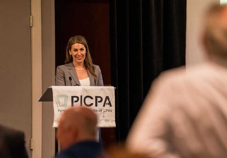 PICPA CEO Jennifer Cryder standing at podium before attendees