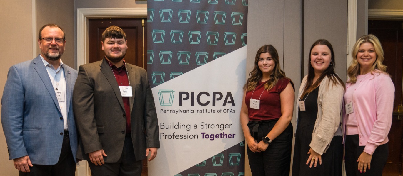 A group of CPAs standing around a PICPA banner