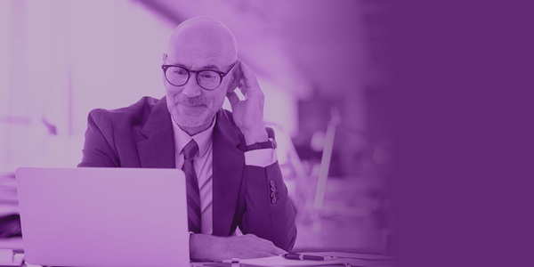 ID214-_1200 x 628 Mid aged businessman sitting at a laptop