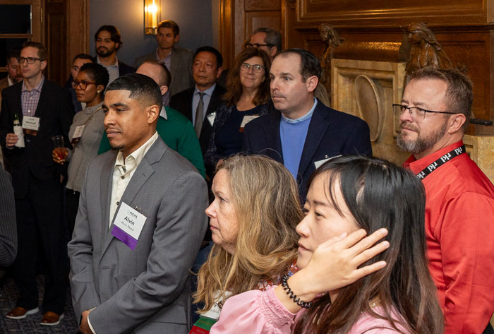 Large group of business professionals focused on an out-of-frame speaker