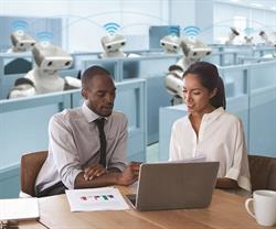 AccountingAutomation CPA with client while robots do work in the background.