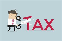 Cartoon of man cutting "Tax" with giant scissors