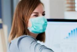 Mask Wearing Office worker wearing a protective mask