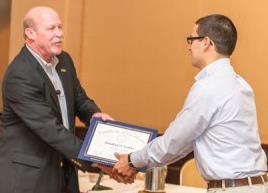 Mike Colgan congratulating scholarship winner