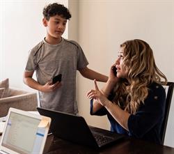 Work from home mother halting an interrupting son