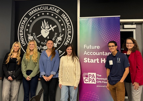 A group of people posing around a CPA Foundation banner