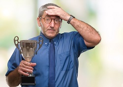 A man who received an award seemingly distracted by other worries