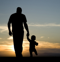Father and son in field at sunset: work-life balance