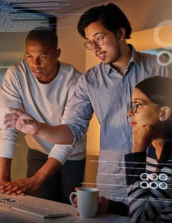 Three colleagues looking over a project and discussing it.