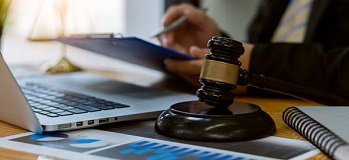 Judge's gavel in the middle of a busy CPA's desk