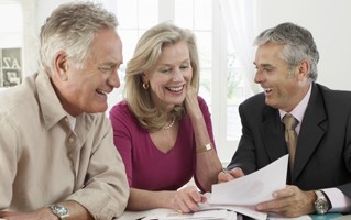Soon to be retired couple speaking with their financial planner
