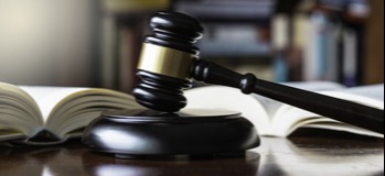 Judge's gavel in front of open law books