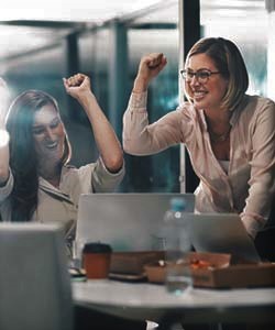 Two coworkers celebrating a work victory together