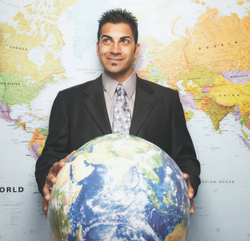 Future CPA holding a globe while standing infront of a world map.