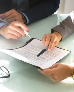 Two CPAs closely reviewing a lease document